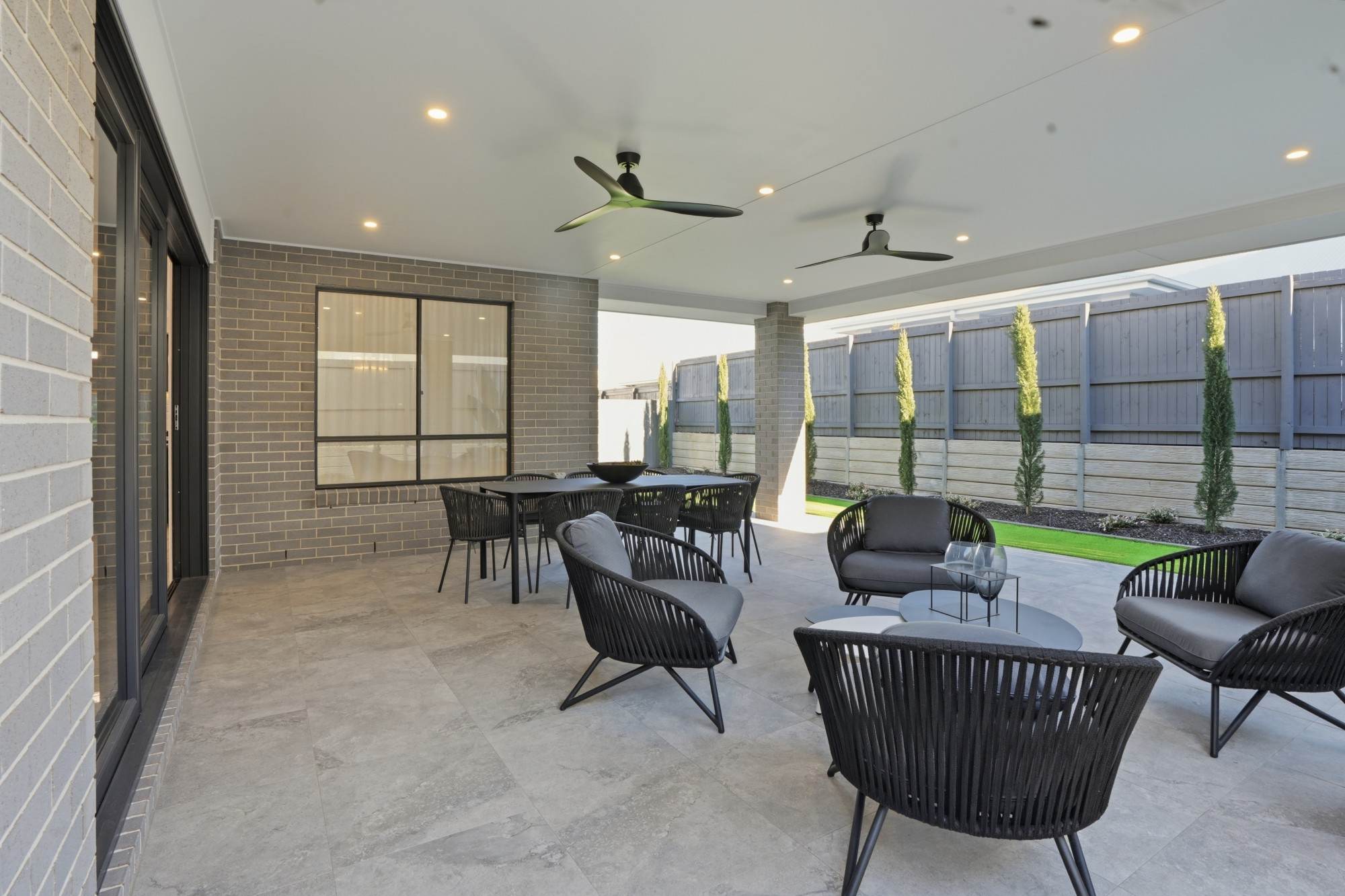 Covered alfresco with outdoor lounge and dining, ceiling fans and landscaped side garden