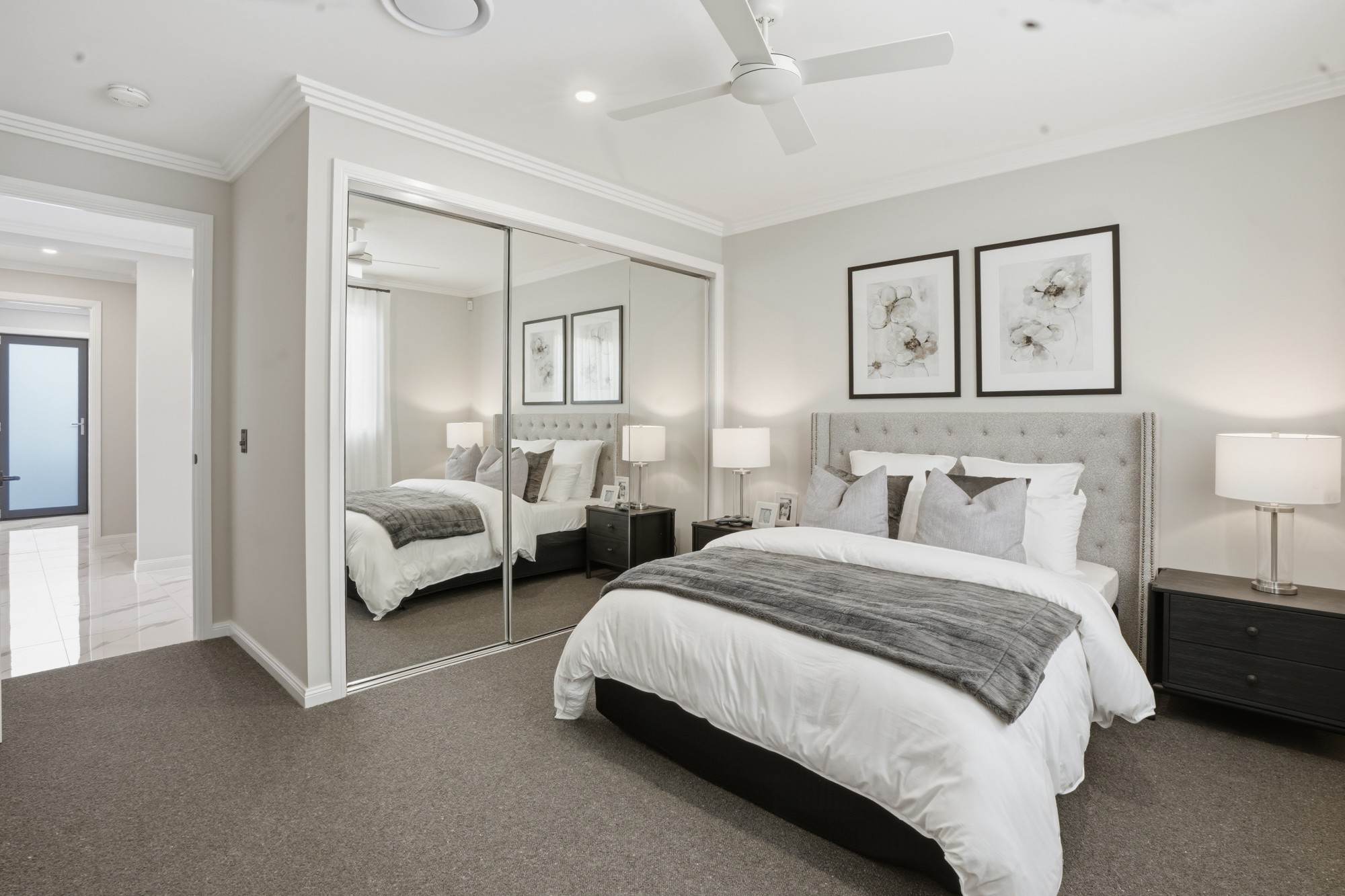 Bedroom with tufted headboard and mirrored built-in robe
