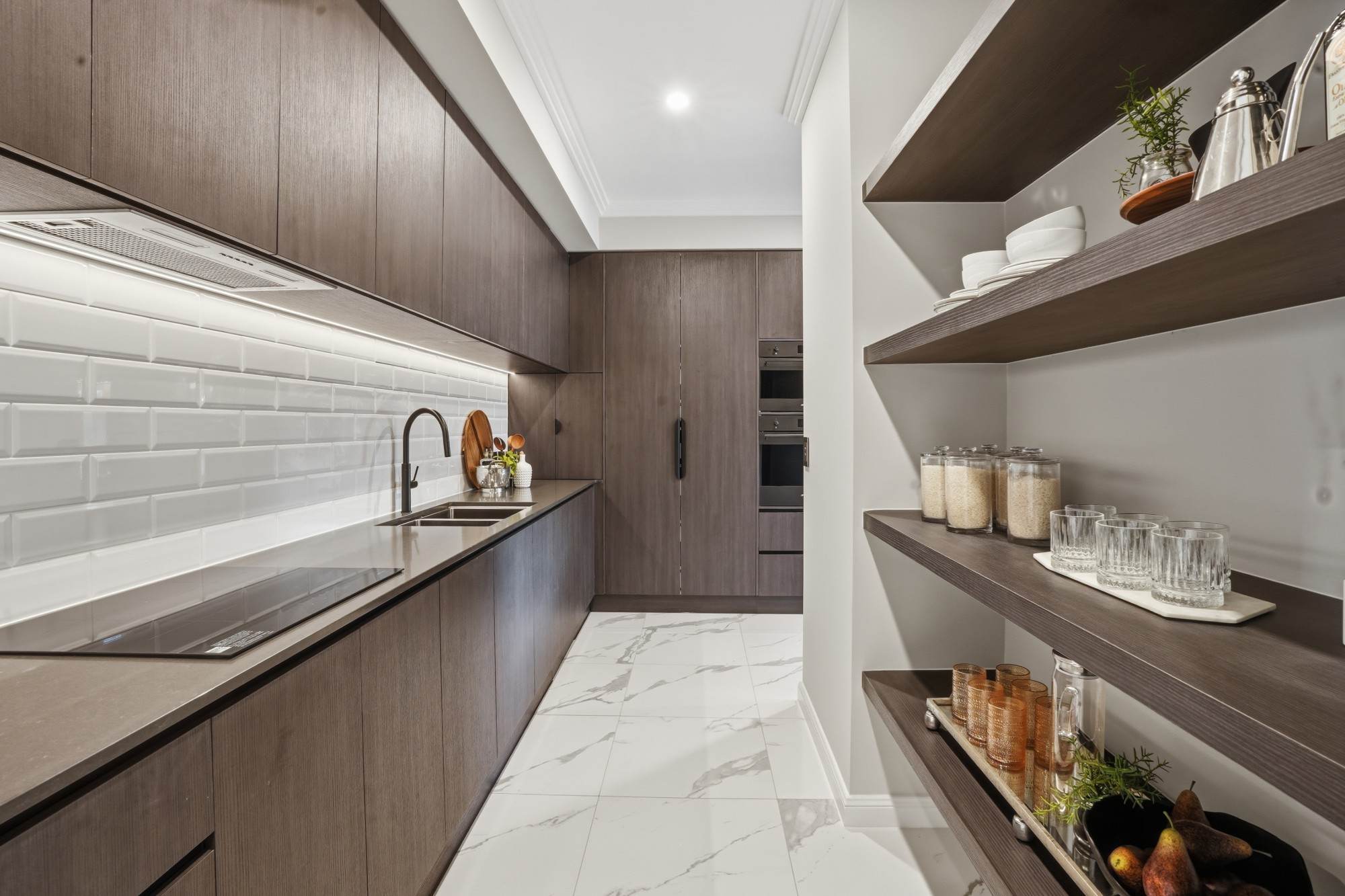 Butler’s pantry with timber cabinetry, open shelving and subway tile splashback