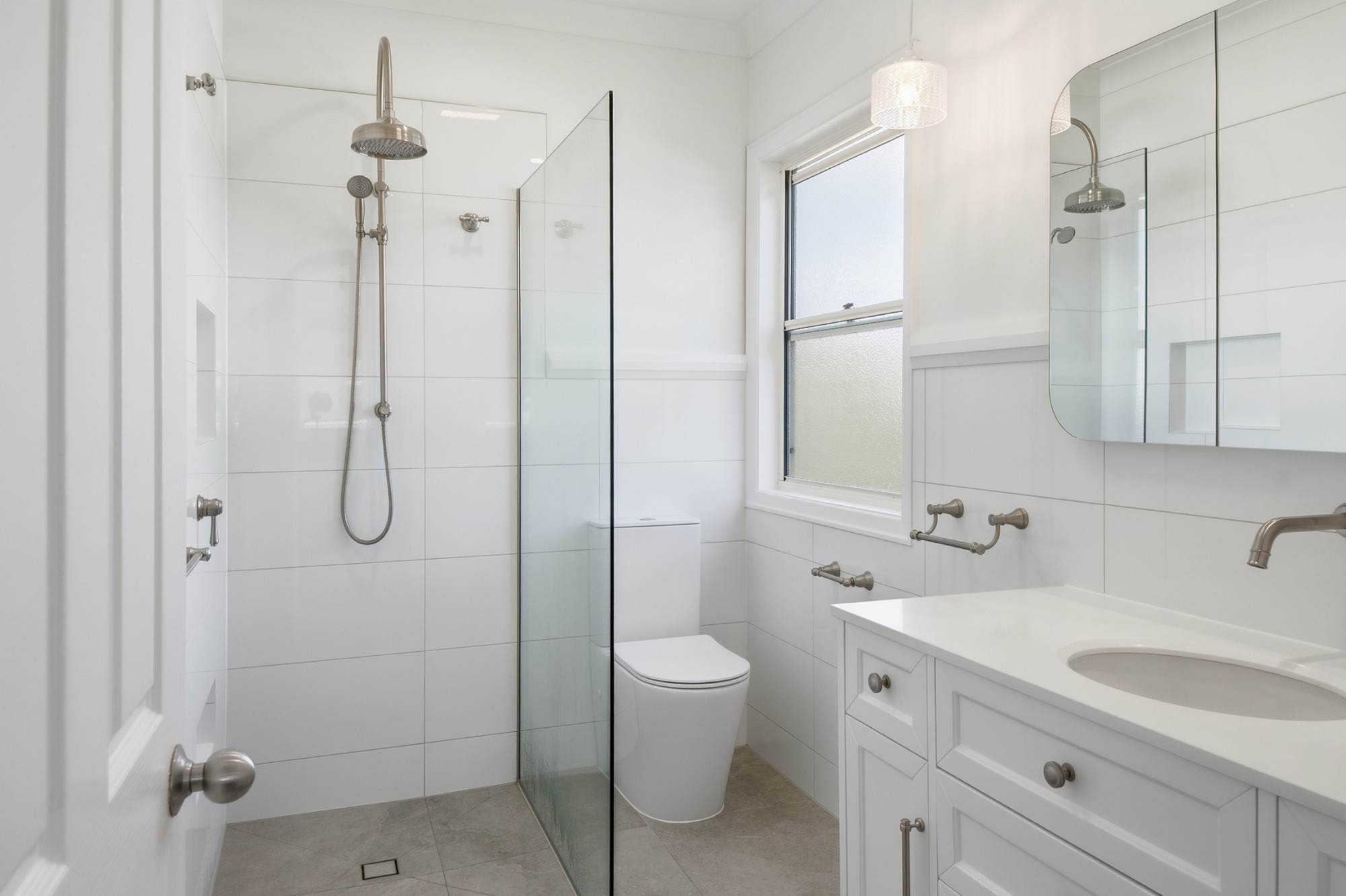 Ensuite vanity with undermount basin, arched mirror cabinet and pendant light