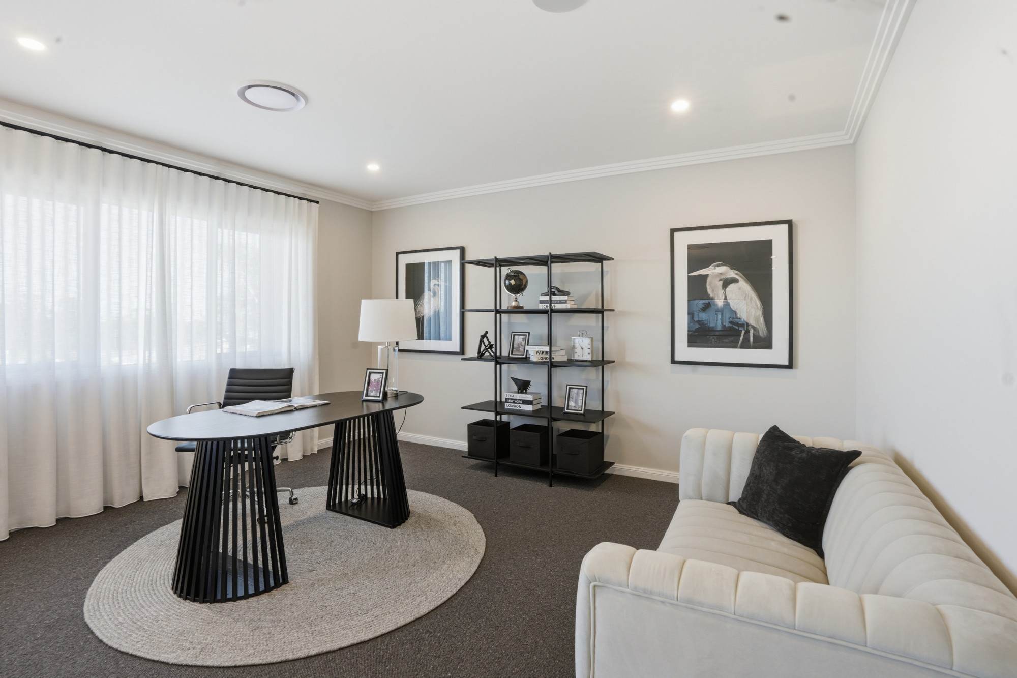 Home study with slatted timber desk, open shelving and heron prints